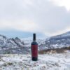 bottle of wine on top of a mountain