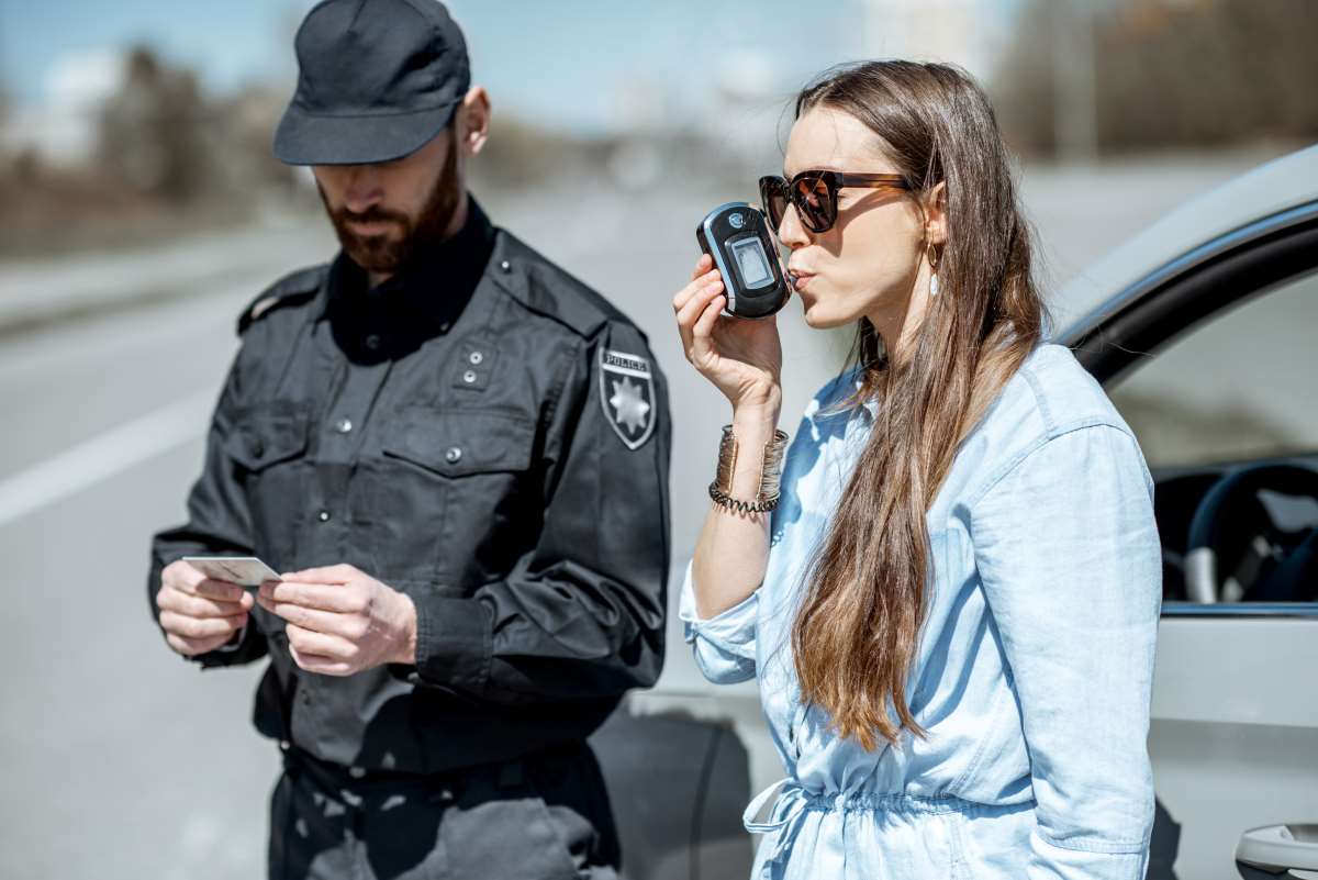 woman breathing into a breathalyser