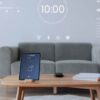 A digital tablet displaying a smart home controller sits on a wooden table, highlighting smart home breathalyser integration.