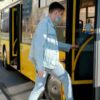 A young man rides the city bus, reflecting the importance of alcohol testing on public transportation.