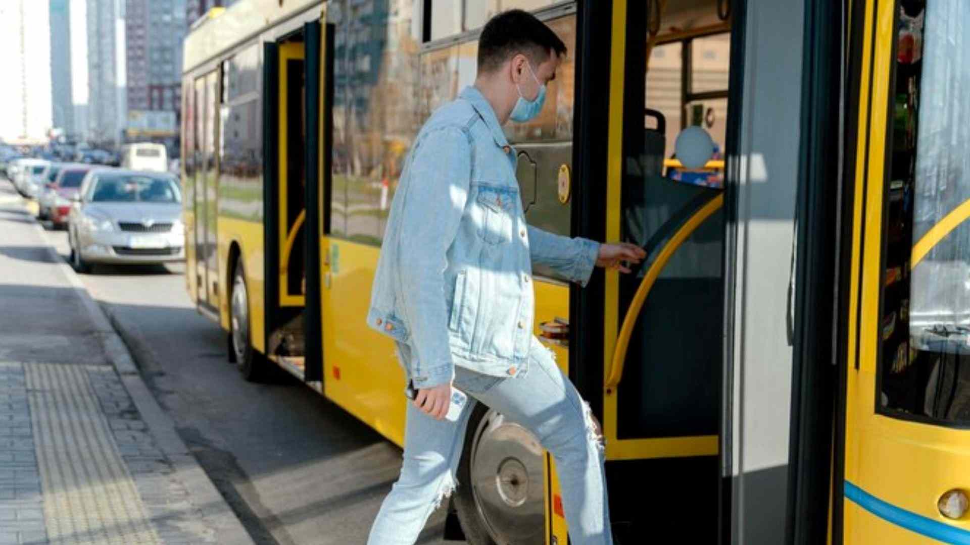 A young man rides the city bus, reflecting the importance of alcohol testing on public transportation.