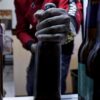 The midsection of a man taking a bottle of beer out of the fridge highlights the importance of responsible alcohol delivery.