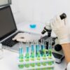 person using computer and test tubes to show how Testing BAC Varies