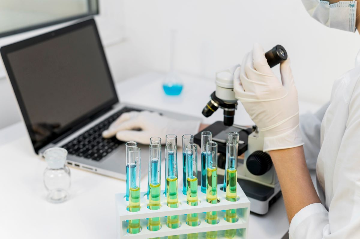 person using computer and test tubes to show how Testing BAC Varies