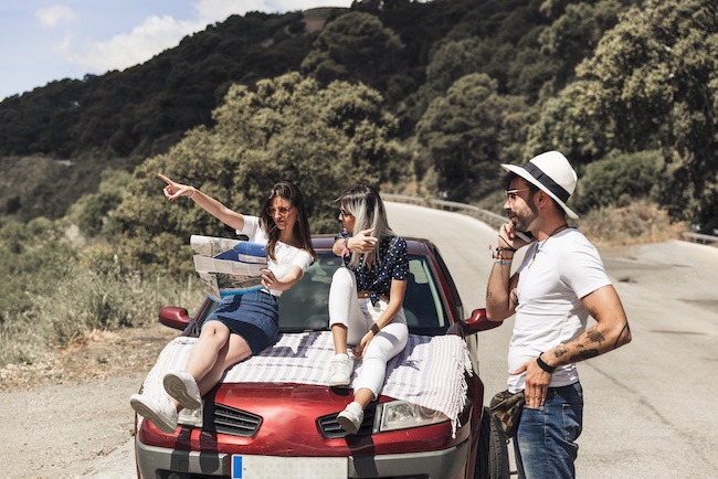 female friends discussing road trip with breathalysers