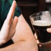 man resists alcoholic beverage as he is preparing for breathalyser test