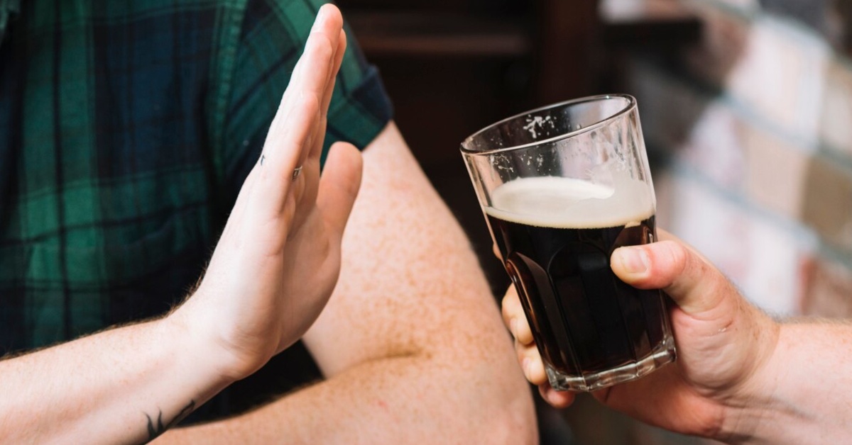 man resists alcoholic beverage as he is preparing for breathalyser test