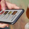 woman uses gamified breathalyser app on phone