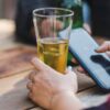 woman drinking beer using drinking app