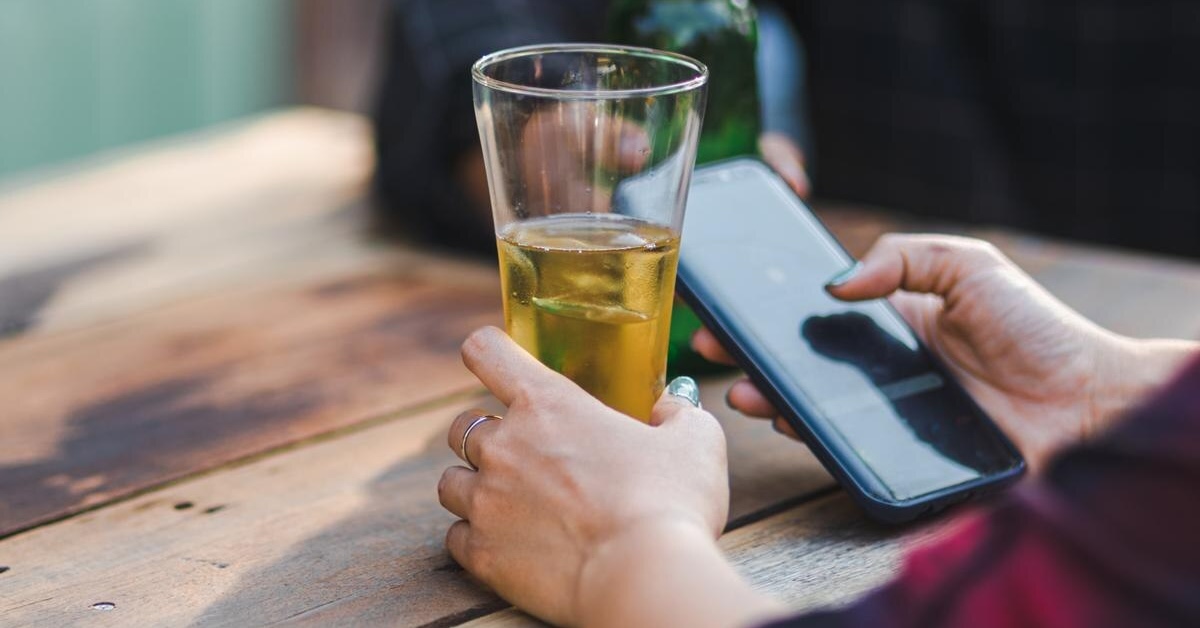 woman drinking beer using drinking app