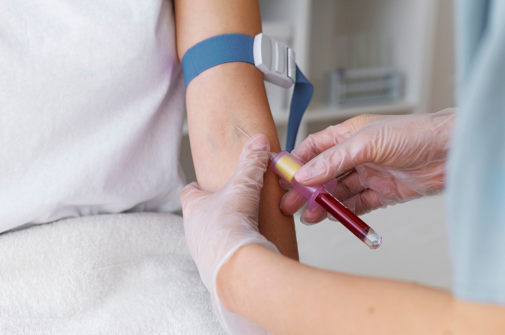 A nurse conducts a blood test as part of alcohol detection, highlighting the differences in accuracy between breathalysers vs blood tests.