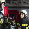 male and female firefighters discuss using breathalysers in emergency services