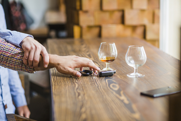 man avoiding taking car keys before breathalyser use